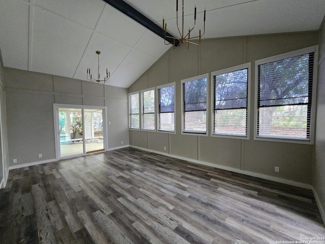 interior space featuring a healthy amount of sunlight, vaulted ceiling with beams, and a chandelier