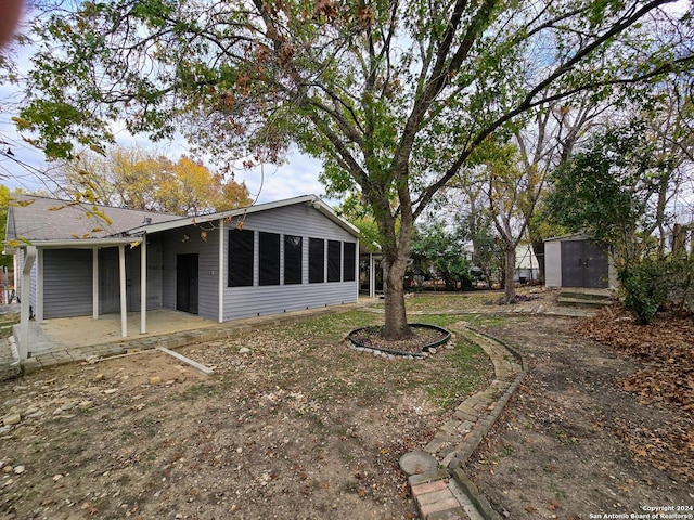 view of yard with a storage unit and a patio