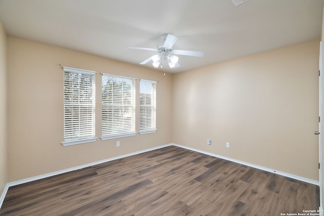 unfurnished room with dark hardwood / wood-style floors and ceiling fan