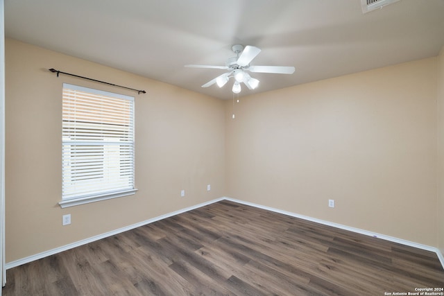 spare room featuring ceiling fan and dark wood-type flooring