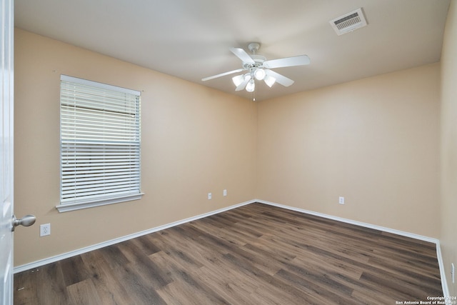 unfurnished room with plenty of natural light, ceiling fan, and dark hardwood / wood-style flooring