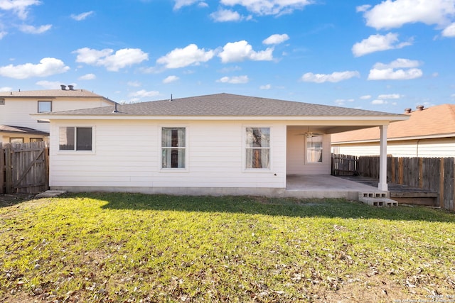 back of property featuring a lawn, ceiling fan, and a patio area