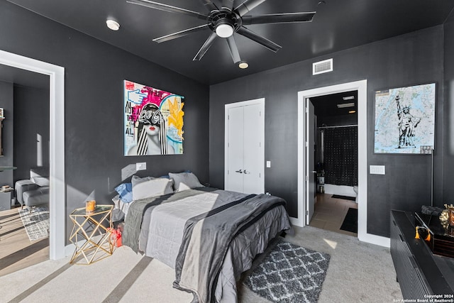 bedroom with carpet flooring, connected bathroom, and ceiling fan