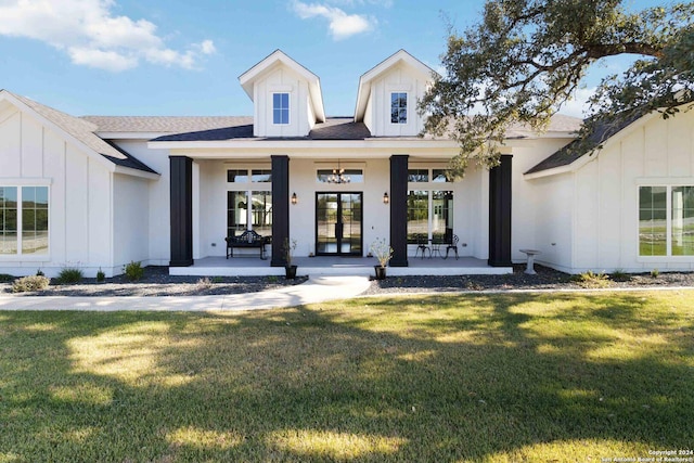 doorway to property with covered porch and a yard