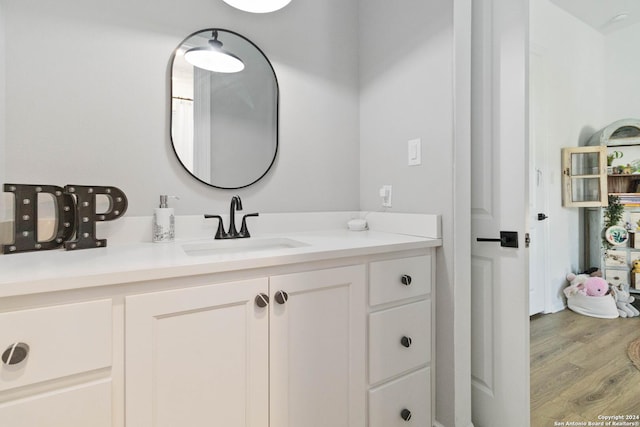 bathroom with vanity and hardwood / wood-style flooring