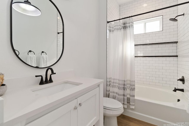 full bathroom featuring vanity, toilet, wood-type flooring, and shower / tub combo