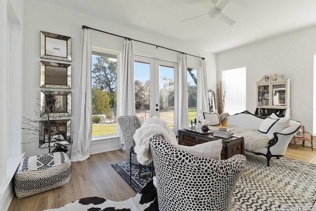 living room featuring hardwood / wood-style flooring, ceiling fan, and french doors