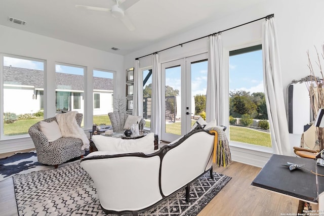 sunroom / solarium with french doors, ceiling fan, and a healthy amount of sunlight