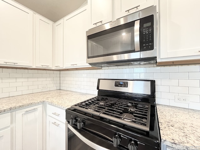 kitchen featuring white cabinetry and appliances with stainless steel finishes