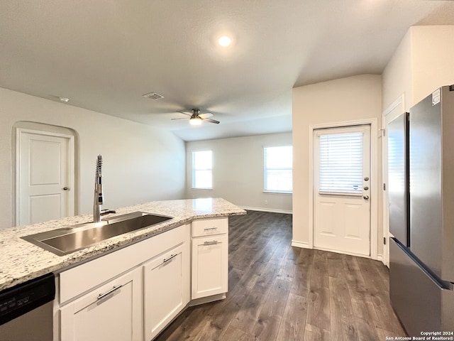 kitchen featuring light stone countertops, dishwasher, sink, ceiling fan, and white cabinets