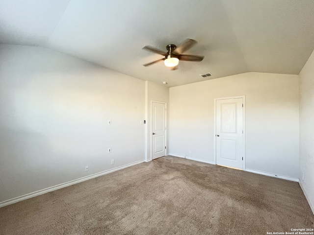 carpeted empty room featuring ceiling fan and lofted ceiling