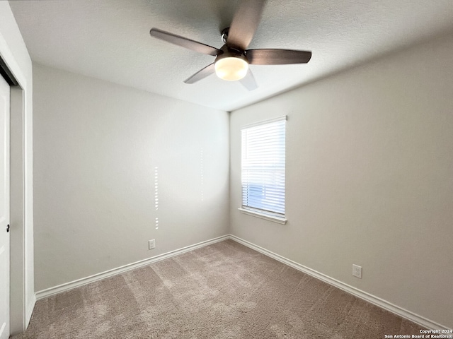 unfurnished bedroom with carpet, a closet, and ceiling fan