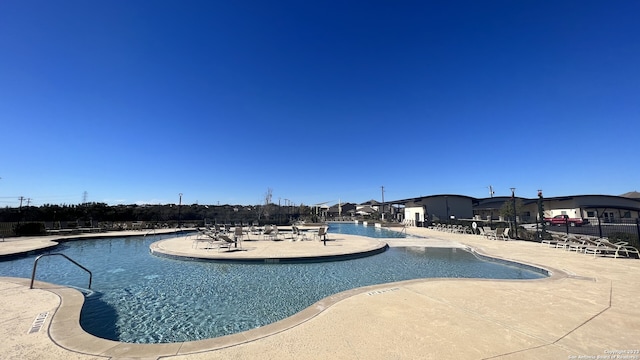 view of swimming pool featuring a patio area