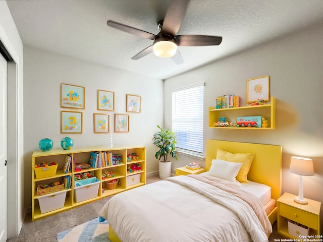 carpeted bedroom featuring ceiling fan and a closet