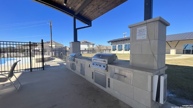 view of patio featuring area for grilling and a grill