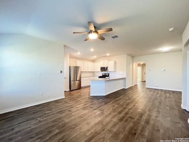 kitchen with dark hardwood / wood-style flooring, tasteful backsplash, stainless steel appliances, white cabinetry, and lofted ceiling