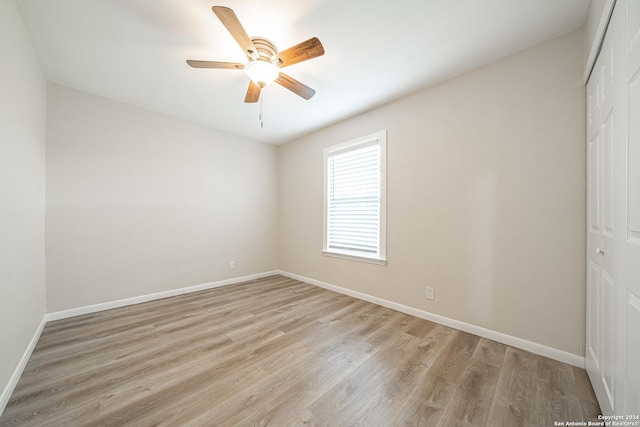 empty room featuring ceiling fan and light hardwood / wood-style floors