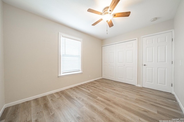 unfurnished bedroom with ceiling fan and light wood-type flooring