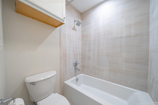 bathroom featuring shower / washtub combination and toilet