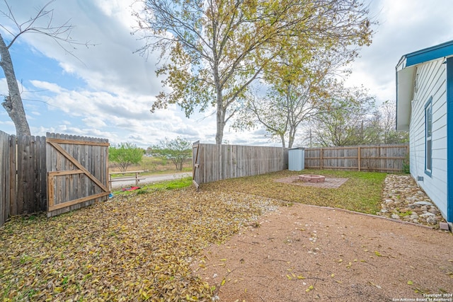 view of yard with a fire pit