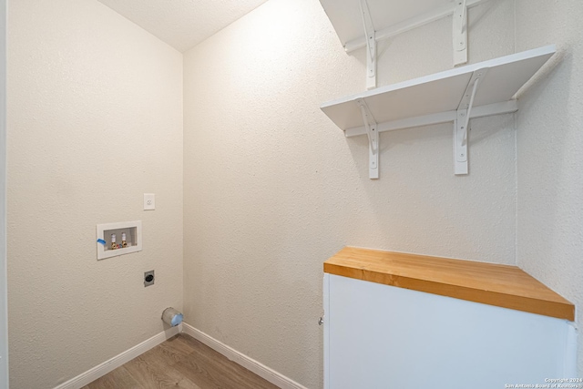 laundry room with hookup for an electric dryer, hardwood / wood-style floors, and washer hookup