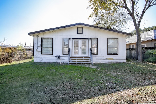 rear view of house with a lawn