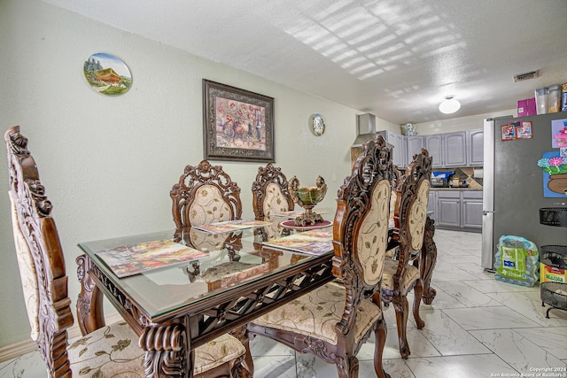 dining room featuring a textured ceiling