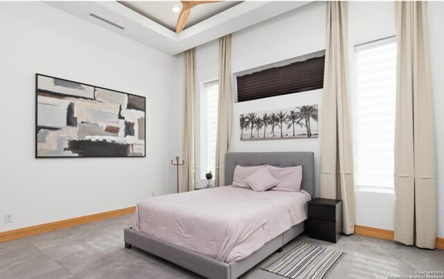 bedroom featuring ceiling fan and multiple windows