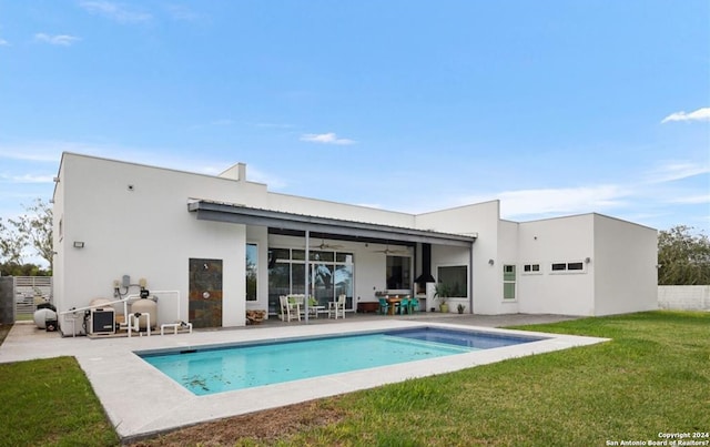 back of house with a lawn, ceiling fan, and a patio