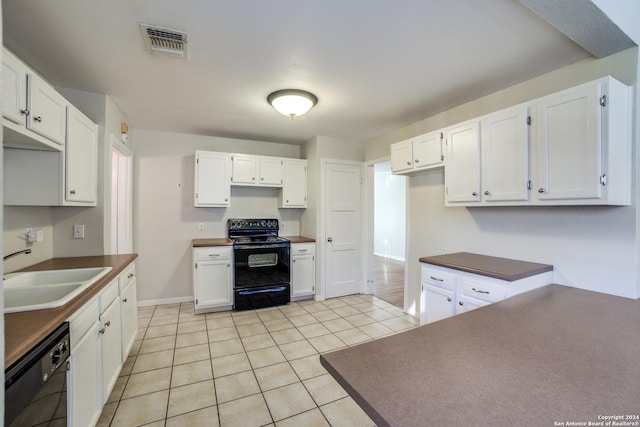 kitchen featuring black appliances, light tile patterned flooring, white cabinetry, and sink