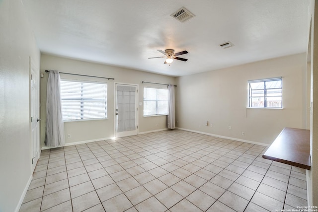 unfurnished room featuring light tile patterned floors and ceiling fan