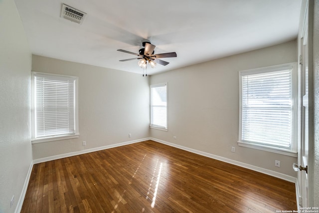 empty room featuring dark hardwood / wood-style flooring and ceiling fan