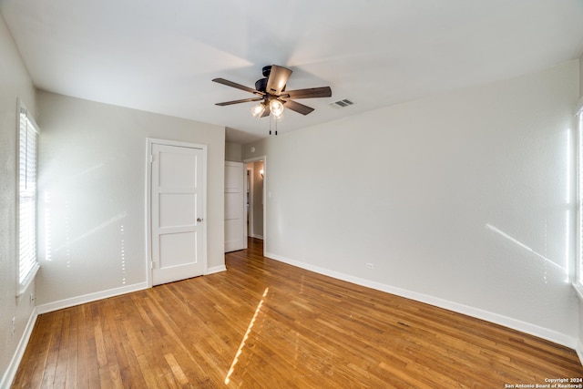 empty room featuring hardwood / wood-style flooring and ceiling fan