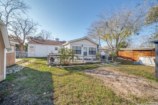 rear view of property featuring a lawn