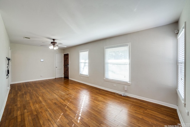 spare room featuring dark hardwood / wood-style flooring and ceiling fan