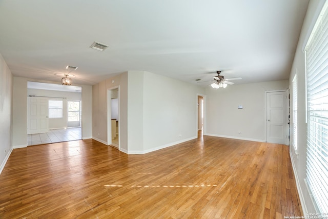 empty room with light hardwood / wood-style floors and ceiling fan