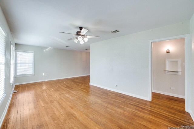 empty room featuring light wood-type flooring and ceiling fan