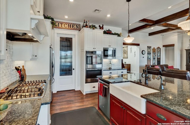 kitchen with pendant lighting, white cabinets, dark hardwood / wood-style floors, beam ceiling, and stainless steel appliances