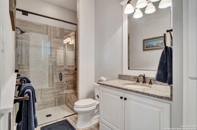 bathroom featuring vanity, toilet, and walk in shower