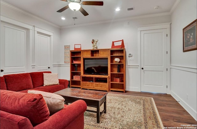 living room with wood-type flooring, ceiling fan, and crown molding