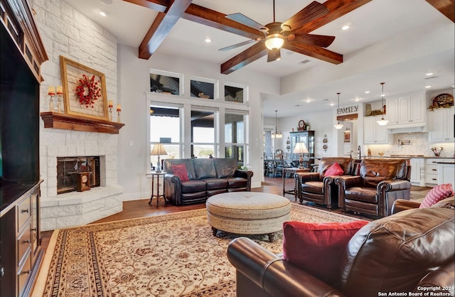 living room featuring beam ceiling, a fireplace, ceiling fan, and dark hardwood / wood-style flooring