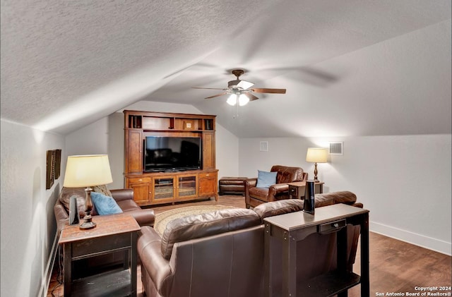 living room with a textured ceiling, ceiling fan, dark hardwood / wood-style flooring, and lofted ceiling