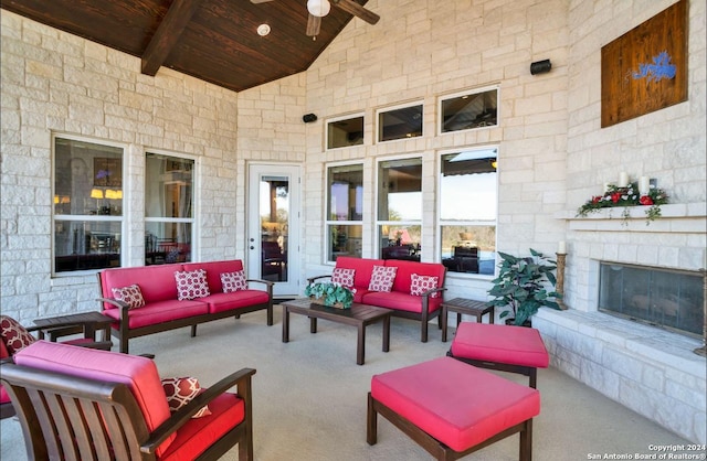 view of patio / terrace featuring an outdoor living space with a fireplace and ceiling fan