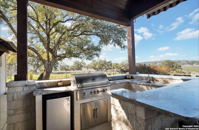 view of patio / terrace with grilling area and an outdoor kitchen