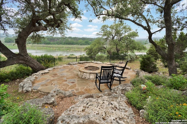 769 Pacific Pl, Spring Branch, TX 78070 - view of patio with a fire pit and a water view