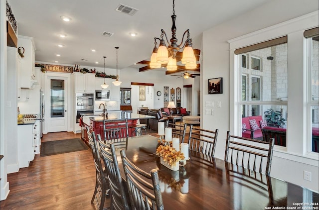 dining space featuring ceiling fan with notable chandelier and dark hardwood / wood-style floors