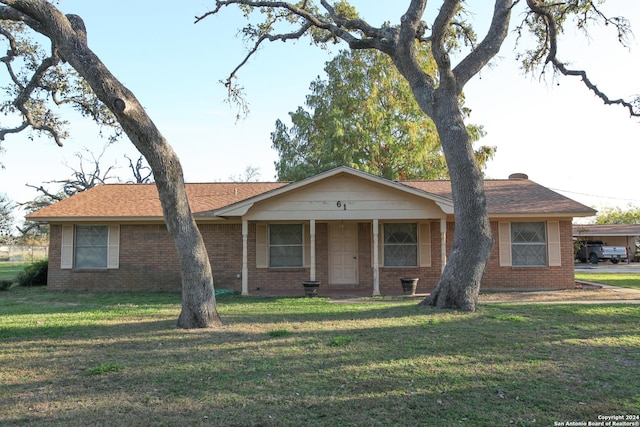 ranch-style home with covered porch and a front lawn