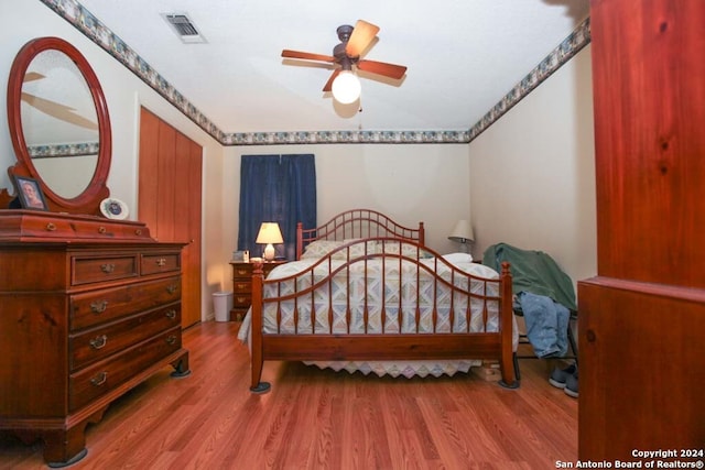 bedroom with hardwood / wood-style flooring and ceiling fan