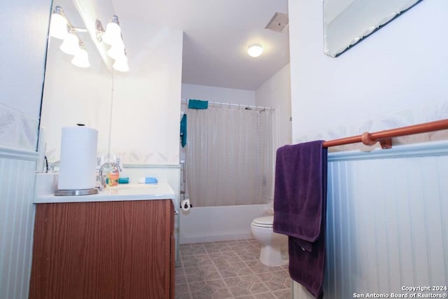 full bathroom featuring vanity, shower / bath combination with curtain, and toilet