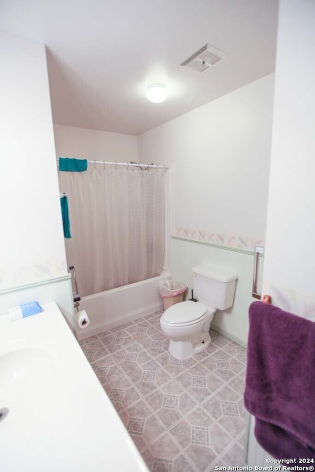 bathroom with toilet and shower / bathtub combination with curtain